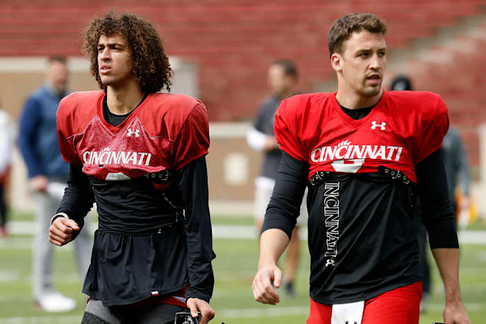 Cincinnati Bearcats quarterbacks Evan Prater (3) and Ben Bryant (6) finish a session during a spring practice at Nippert Stadium in Cincinnati on Thursday, March 24, 2022. Cincinnati Bearcats Spring Practice